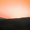 A sunset over a hill.