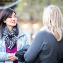 two women having a discussion outside