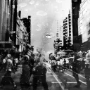 Crowds of people walking a street.