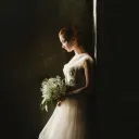 a bride standing alone and looking at the ground