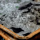 a rusty tub holding dark, bubbly water