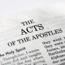 A Bible opened to the book of Acts.