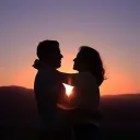 a silhouette of a man and a woman hugging with the sunset in the background