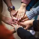 several hands extended to one another in a group