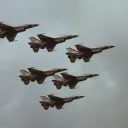 six fighter jets in a gray sky
