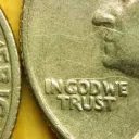 Close up of United States quarter displaying the phrase "In God We Trust".