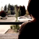 A woman looking out a window.