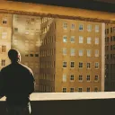 A man looking buildings in a large city.