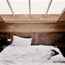 A person sleeping in a bed.