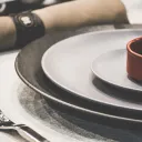 A table set with plates for a dinner.