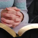 A person holding a Bible.