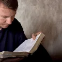 A man reading a Bible.