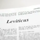 A Bible opened to the beginning of the book of Leviticus.