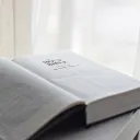 An open Bible laying on a table.