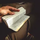 A person holding a Bible.