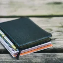 Bible, notebook and pen on a table.
