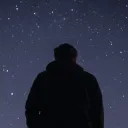 A young person looking up at the stars.