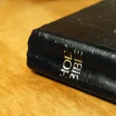 A Bible laying on a table.