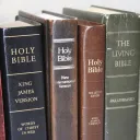 Various Bibles on a shelf.