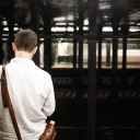 A man waiting at a subway station.