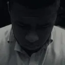 A young man with his head down.