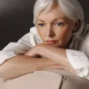 An older woman thinking.
