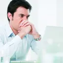 A man looking at his laptop screen.