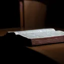 An open Bible laying on a table.