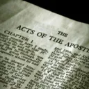 Page of the Bible opened to Acts.