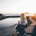 A young woman with a blanket shawl wrapped around her.