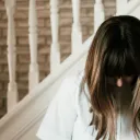 A woman with head bowed in prayer.