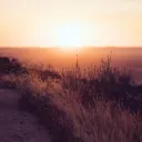 A sunset over a hill.