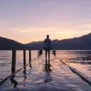 A man standing on a dock covered by water.