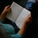 A person reading a Bible.