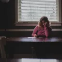 A woman sitting a table.