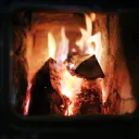 A fire burning inside a wood stove.