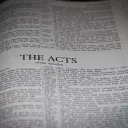 A Bible opened to the book of Acts.