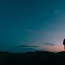 A young man looking up at the night sky.