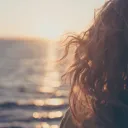 A young woman looking out over the ocean.