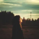 A young woman looking up at the sky.