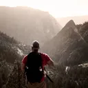 A man hiking on a mountain trail.