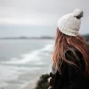 A young woman looking out over the ocean.
