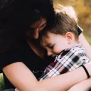 A mother holding her young son.