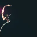 A young man with his head down.