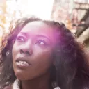 A young woman walking and looking up.