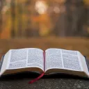 An open Bible laying on a table.