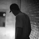 A man in a dark hallway.