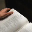 A woman reading a Bible.