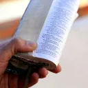 A man holding a Bible in his hand.