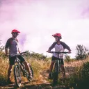 A dad and son riding mountain bikes.